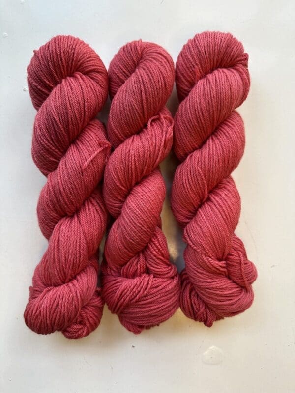 Colorway: Red Rose Length: 246 yards/225 meters. 100 Grams. Light Red Rose DK 100 % Merino. Experience the beauty of naturally dyed yarn with Red Rose Yarn showcasing a rich red hue.  Crafted from 100% superwash Merino wool, this 4-ply naturally-dyed yarn showcases a rich red hue.  100 grams/246 yards/225 meters. Perfect for knitting or crocheting projects, Red Rose DK 100% Merino wool yarn is sourced from Uruguay. Elevate your creations with this exquisite and sustainable yarn. Care Instructions: Machine wash on a gentle cycle using mild detergent. Do not bleach. Dry flat away from direct sunlight.
