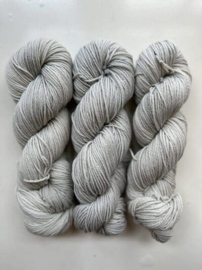 Colorway: Cloudy Day Light.  Experience the beauty of naturally dyed yarn with Cloudy Day Yarn showcasing a moody gray hue.  Crafted from 100% superwash Merino wool, this 4-ply naturally-dyed yarn showcases soft gray days.  100 grams/246 yards/225 meters. Perfect for knitting or crocheting projects, Cloudy Day DK 100% Merino wool yarn is sourced from Uruguay. Elevate your creations with this exquisite and sustainable yarn. Care Instructions: Machine wash on a gentle cycle using mild detergent. Do not bleach. Dry flat away from direct sunlight.