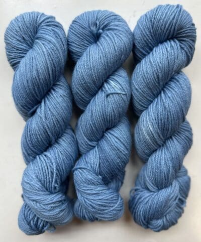 Blue Colorway: Variegated Cornflower. Length: 437 yds / 400 meters. 100 g Variegated Cornflower DK yarn, a naturally dyed blend of 75% Superwash Merino and 25% nylon. This Peru-origin yarn is hand-dyed using plant-based dyes, resulting in an eco-friendly option. Perfect for knitting or crocheting projects. <strong>While our team hand-dyes each skein with the utmost care, natural dyes results can vary based on plant materials and fibers. Please be aware that variations in color and appearance may vary f</strong>  