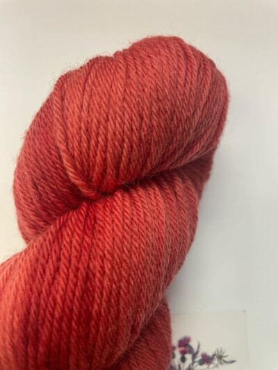 Colorway: Red Dahlia Dark Length: 246 yards/225 meters. 100 Grams Dark Red Dahlia DK 100% Merino. Experience the beauty of naturally dyed dark red yarn.  Crafted from 100% superwash Merino wool, this 4-ply naturally-dyed yarn showcases a rich red hue.  100 grams/246 yards/225 meters.   Perfect for knitting or crocheting projects, Red Dahlia Dark DK 100% Merino wool yarn is sourced from Uruguay. Elevate your creations with this exquisite and sustainable yarn. Care Instructions: Machine wash on a gentle cycle using mild detergent. Do not bleach. Dry flat away from direct sunlight.