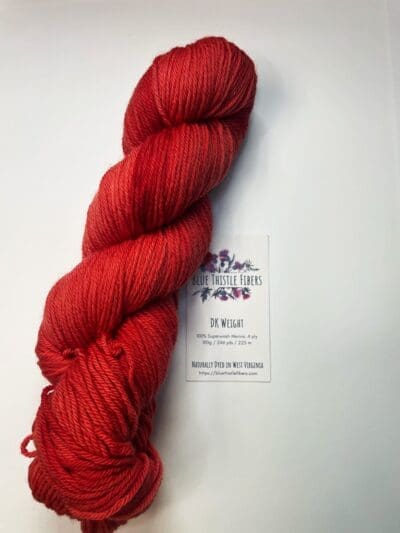 Colorway: Red Dahlia Dark Length: 246 yards/225 meters. 100 Grams Dark Red Dahlia DK 100% Merino. Experience the beauty of naturally dyed dark red yarn.  Crafted from 100% superwash Merino wool, this 4-ply naturally-dyed yarn showcases a rich red hue.  100 grams/246 yards/225 meters.   Perfect for knitting or crocheting projects, Red Dahlia Dark DK 100% Merino wool yarn is sourced from Uruguay. Elevate your creations with this exquisite and sustainable yarn. Care Instructions: Machine wash on a gentle cycle using mild detergent. Do not bleach. Dry flat away from direct sunlight.