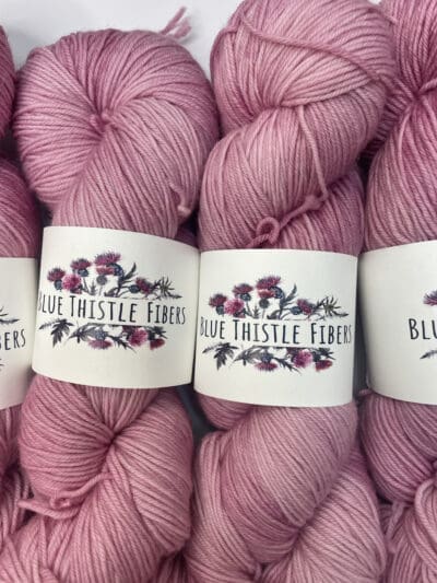 Colorway: Hibiscus.  Length: 437 yds / 400 meters. 100 Grams. Our Variegated Hibiscus sock 4-ply  yarn is a naturally dyed variation in our pink colorway. Sock yarn Made from 75% Superwash Merino Wool and 25% Recycled Nylon, this 4-ply yarn from Peru is strong and light. Perfect for everyday garment projects. Machine washable and easy to care for. Care Instructions: Machine wash on a gentle cycle using mild detergent. Do not bleach. Dry flat away from direct sunlight. <strong>While our team hand-dyes each skein with the utmost care, natural dyes results can vary based on plant materials and fibers. Please be aware that variations in color and appearance may vary from the display image. </strong> <table width="472"> <tbody> <tr> <td><strong>Metric</strong></td> <td><strong>US Knitting Needle</strong></td> <td><strong>Crochet Hook</strong></td> </tr> <tr> <td style="font-style: inherit; font-weight: inherit;">3.25 mm</td> <td style="font-style: inherit; font-weight: inherit;">US 1-2</td> <td style="font-style: inherit; font-weight: inherit;">D3</td> </tr> </tbody> </table>   <table width="472"> <tbody> <tr> <td><strong>Stitches per Inch</strong></td> </tr> <tr> <td style="font-style: inherit; font-weight: inherit;">30 st/4″ or 7-8 st/1″</td> </tr> </tbody> </table>  