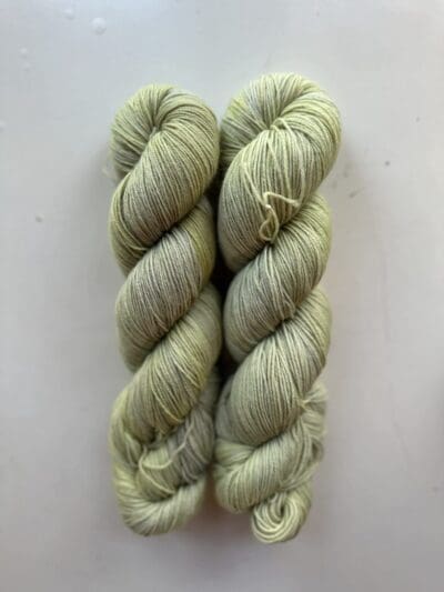 <div class="woocommerce-product-details__short-description"> Greem Colorway: Dark Variegated  Sage. Length: 437 yds / 400 meters. 100 Grams Dark Variegated Sage Sock yarn made from 75% Superwash Merino Wool and 25% Recycled Nylon, this 4-ply yarn from Peru is strong and light. Perfect for everyday garment projects. Machine washable and easy to care for. Care Instructions: Machine wash on a gentle cycle using mild detergent. Do not bleach. Dry flat away from direct sunlight. <strong>While our team hand-dyes each skein with the utmost care, natural dyes results can vary based on plant materials and fibers. Please be aware that variations in color and appearance may vary from the display image.  </strong> <table width="472"> <tbody> <tr> <td><strong>Metric</strong></td> <td><strong>US Knitting Needle</strong></td> <td><strong>Crochet Hook</strong></td> </tr> <tr> <td style="font-style: inherit; font-weight: inherit;">3.25 mm</td> <td style="font-style: inherit; font-weight: inherit;">US 1-2</td> <td style="font-style: inherit; font-weight: inherit;">D3</td> </tr> </tbody> </table>   <table width="472"> <tbody> <tr> <td><strong>Stitches per Inch</strong></td> </tr> <tr> <td style="font-style: inherit; font-weight: inherit;">30 st/4″ or 7-8 st/1″</td> </tr> </tbody> </table>   </div>  