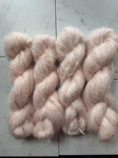 Pink Colorway: Pink Petals 437 yards/400 meters. 50 Grams. Light Pink Petals Mohair is our 1-ply. made from 70% Super Kid Mohair, 30% Mulberry Silk, is silky soft and perfect for an entire sweater or to be threaded with one of our wool yarns.