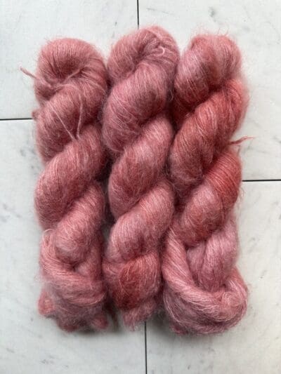 Pink Colorway: Strawberry. 437 yards/400 meters. 50 Grams. Light Strawberry Mohair is our 1-ply. made from 70% Super Kid Mohair, 30% Mulberry Silk, is silky soft and perfect for an entire sweater or to be threaded with one of our wool yarns.