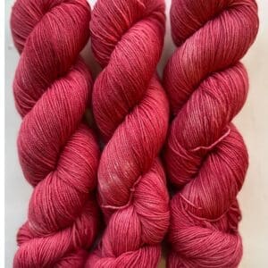 Colorway: Red Dahlia Dark Length: 246 yards/225 meters. 100 Grams Dark Red Dahlia DK 100% Merino. Experience the beauty of naturally dyed dark red yarn.  Crafted from 100% superwash Merino wool, this 4-ply naturally-dyed yarn showcases a rich red hue.  100 grams/246 yards/225 meters.   Perfect for knitting or crocheting projects, Red Dahlia Dark DK 100% Merino wool yarn is sourced from Uruguay. Elevate your creations with this exquisite and sustainable yarn. Care Instructions: Machine wash on a gentle cycle using mild detergent. Do not bleach. Dry flat away from direct sunlight.