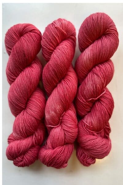 Colorway: Red Rose. Length: 437 yds / 400 meters. 100 Grams. Our Variegated Red Rose sock wool yarn is a naturally dyed variation in our red colorway.  Made from 75% Superwash Merino Wool and 25% Recycled Nylon, this 4-ply yarn from Peru is strong and light. Perfect for everyday garment projects. Length: 437 yds / 400 meters   <table width="472"> <tbody> <tr> <td><strong>Metric</strong></td> <td><strong>US Knitting Needle</strong></td> <td><strong>Crochet Hook</strong></td> </tr> <tr> <td style="font-style: inherit; font-weight: inherit;">3.25 mm</td> <td style="font-style: inherit; font-weight: inherit;">US 1-2</td> <td style="font-style: inherit; font-weight: inherit;">D3</td> </tr> </tbody> </table>   <table width="472"> <tbody> <tr> <td><strong>Stitches per Inch</strong></td> </tr> <tr> <td style="font-style: inherit; font-weight: inherit;">30 st/4″ or 7-8 st/1″</td> </tr> </tbody> </table> Machine washable and easy to care for. Care Instructions: Machine wash on a gentle cycle using mild detergent. Do not bleach. Dry flat away from direct sunlight. <strong>While our team hand-dyes each skein with the utmost care, natural dyes results can vary based on plant materials and fibers. Please be aware that variations in color and appearance may vary from the display image.  </strong>