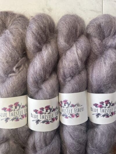 Purple Colorway: Dark Lavendera. 437 yards/400 meters. 50 Grams. Dark Lavender Mohair is our 1-ply. made from 70% Super Kid Mohair, 30% Mulberry Silk, is silky soft and perfect for an entire sweater or to be threaded with one of our wool yarns.