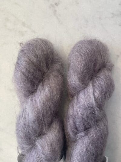 Purple Colorway: Dark Lavendera. 437 yards/400 meters. 50 Grams. Dark Lavender Mohair is our 1-ply. made from 70% Super Kid Mohair, 30% Mulberry Silk, is silky soft and perfect for an entire sweater or to be threaded with one of our wool yarns.