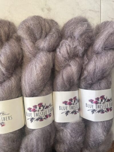 Purple Colorway: Dark Lavendera. 437 yards/400 meters. 50 Grams. Dark Lavender Mohair is our 1-ply. made from 70% Super Kid Mohair, 30% Mulberry Silk, is silky soft and perfect for an entire sweater or to be threaded with one of our wool yarns.