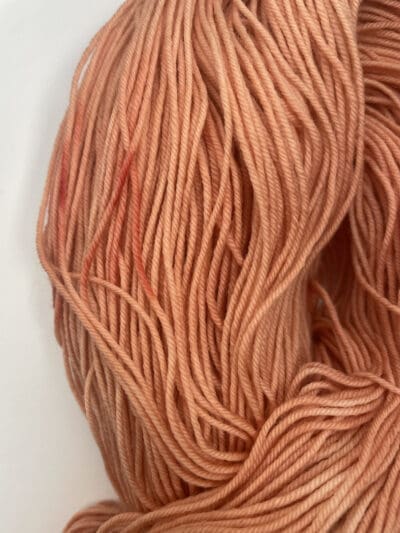 Orange Colorway: Variegated Dark Pumpkin Spice Sockk. Length: 437 yds / 400 meters. 100 Grams. Variegated Dark Pumpkin Spice Sock 4-ply sock yarn, a naturally dyed blend of 75% Superwash Merino and 25% nylon. This Peru-origin yarn is hand-dyed using plant-based dyes, resulting in an eco-friendly option. Perfect for knitting or crocheting projects. Care Instructions: Hand wash in cold water with a gentle detergent made specifically for washing wool and other fine fibers, or a PH-neutral, dye free detergent. Lay flat to dry. <strong>While our team hand-dyes each skein with the utmost care, natural dyes results can vary based on plant materials and fibers. Please be aware that variations in color and appearance may vary from the display image.  </strong>  