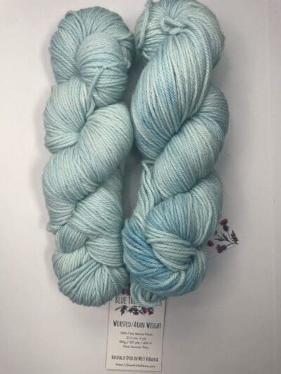 Blue Colorway: Variegated Light Hydrangea Aran. Length: 219 yds. / 200 m/ 100g. Non-Superwash. Wool Country: Peru. Variegated Light Hydrangea Aran 21.5 mic 4-ply yarn is non-superwash naturally dyed with sustainably harvested/foraged dye material from plants, minerals, roots, trees, and other organic materials. Blue Thistle Fiber’s 4-ply Aran yarn is certified mulesing-free non-SW 100% Merino wool and quickly works up into hats and sweaters everyone will love to wear. A durable yarn that holds up to washing and wearing. Care Instructions: Hand wash in cold water with a gentle detergent made specifically for washing wool and other fine fibers or a PH-neutral, dye-free detergent. Lay flat to dry. <strong>While our team hand-dyes each skein with the utmost care, natural dyes results can vary based on plant materials and fibers. </strong><strong>Please wash before using, as naturally dyed fibers can run the first few washings.</strong> <strong>Please be aware that variations in color and appearance may vary from the display image.</strong>  