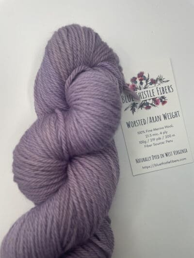 Purple Colorway: Variegated Plum Aran. Length: 219 yds. / 200 m/ 100g. Non-Superwash. Wool Country: Peru. Variegated Plum Aran 21.5 mic 4-ply yarn is non-superwash naturally dyed with sustainably harvested/foraged dye material from plants, minerals, roots, trees, and other organic materials. Blue Thistle Fiber’s 4-ply Aran yarn is certified mulesing-free non-SW 100% Merino wool and quickly works up into hats and sweaters everyone will love to wear. A durable yarn that holds up to washing and wearing. Care Instructions: Hand wash in cold water with a gentle detergent made specifically for washing wool and other fine fibers or a PH-neutral, dye-free detergent. Lay flat to dry. <strong>While our team hand-dyes each skein with the utmost care, natural dyes results can vary based on plant materials and fibers. </strong><strong>Please wash before using, as naturally dyed fibers can run the first few washings.</strong> <strong>Please be aware that variations in color and appearance may vary from the display image.</strong>  