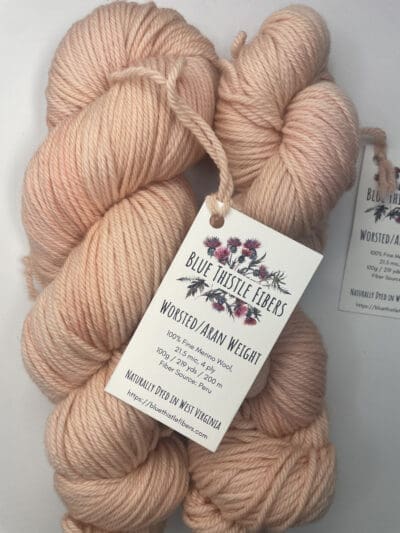 Pink Colorway: Variegated Magnolia. 219 y/200 m/ 100g. Non-Superwash Variegated Magnolia Aran 21.5 mic 4-ply yarn is non-superwash naturally dyed with sustainably harvested/foraged dye material from plants, minerals, roots, trees, and other organic materials. Blue Thistle Fiber’s 4-ply Aran yarn is certified mulesing-free SW 100% Merino wool and quickly works up into hats and sweaters everyone will love to wear. A durable yarn that holds up to washing and wearing. Care Instructions: Machine wash on a gentle cycle using mild detergent. Do not bleach. Dry flat away from direct sunlight. &lt;strong&gt;While our team hand-dyes each skein with the utmost care, natural dyes results can vary based on plant materials and fibers. &lt;/strong&gt;&lt;strong&gt;Please wash before using, as naturally dyed fibers can run the first few washings.&lt;/strong&gt; &lt;strong&gt;Please be aware that variations in color and appearance may vary from the display image.&lt;/strong&gt; &nbsp;