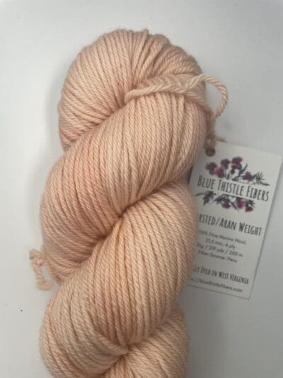 Pink Colorway: Variegated Magnolia. 219 y/200 m/ 100g. Non-Superwash Variegated Magnolia Aran 21.5 mic 4-ply yarn is non-superwash naturally dyed with sustainably harvested/foraged dye material from plants, minerals, roots, trees, and other organic materials. Blue Thistle Fiber’s 4-ply Aran yarn is certified mulesing-free SW 100% Merino wool and quickly works up into hats and sweaters everyone will love to wear. A durable yarn that holds up to washing and wearing. Care Instructions: Machine wash on a gentle cycle using mild detergent. Do not bleach. Dry flat away from direct sunlight. &lt;strong&gt;While our team hand-dyes each skein with the utmost care, natural dyes results can vary based on plant materials and fibers. &lt;/strong&gt;&lt;strong&gt;Please wash before using, as naturally dyed fibers can run the first few washings.&lt;/strong&gt; &lt;strong&gt;Please be aware that variations in color and appearance may vary from the display image.&lt;/strong&gt; &nbsp;