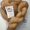 a close-up of a barley colored skein of yarn