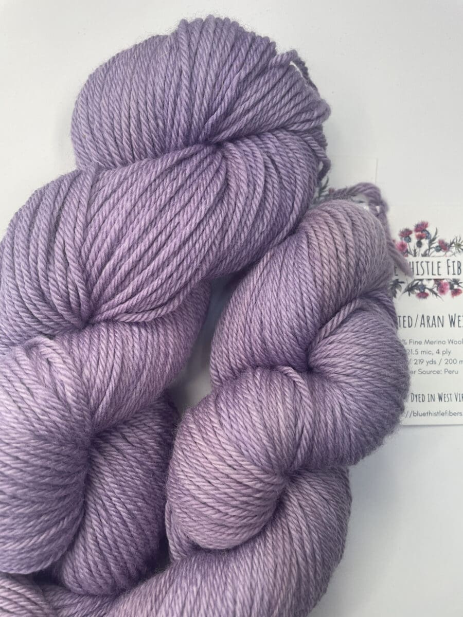Purple Colorway: Variegated Light Violet. Length: 399 yds / 365 Meters 100g Variegated Light Violet 2-ply Fingering yarn, a naturally dyed soft purple and white blend made from 80% Superwash Merino Wool and 20% Recycled Nylon. This Peruvian-made yarn is both eco-friendly and luxurious. Its soft texture and vibrant color make it perfect for creating beautiful knit or crochet projects. Care Instructions: Hand wash in cold water with a gentle detergent made specifically for washing wool and other fine fibers, or a PH-neutral, dye free detergent. Lay flat to dry. Length: 399 yds / 365 Meters. 100 grams. <strong>While our team hand-dyes each skein with the utmost care, natural dyes results can vary based on plant materials and fibers. Please be aware that variations in color and appearance may vary from the display image.  </strong>