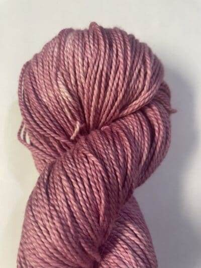 Pink Colorway: Variegated Dark Pink Hibiscus. Length: 383 yards | 350 m | 100 g Variegated Dark Pink Hibiscus eco-sock 4 ply wool yarn is made from 50% Recycled Wool & 50% Tencel for durability.  This variegated colorway has a white streak entwined with dark pink. This sustainable yarn is ethically sourced from Peru and naturally dyed in West Virginia.  This wool has a crisp, bulky feel and is perfect for apparel and other projects.  