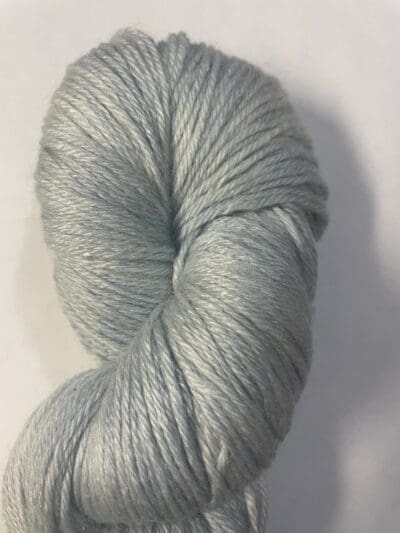 Blue Colorway: Variegated Light Indigo. Length: 383 yards | 350 m | 100 g. Variegated Light Indigo eco-sock 4 ply wool yarn is made from 50% Recycled Wool & 50% Tencel for durability.  This variegated colorway has a white streak entwined with light Indigo. This sustainable yarn is ethically sourced from Peru and naturally dyed in West Virginia.  This wool has a crisp, bulky feel and is perfect for apparel and other projects.  