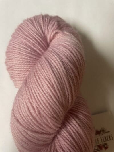 Pink Colorway: Variegated Light Hibiscus. Length: 399 yds / 365 Meters 100g Variegated Light Hibiscus 2-ply Fingering yarn, a naturally dyed soft purple blend made from 80% Superwash Merino Wool and 20% Recycled Nylon. This Peruvian-made yarn is both eco-friendly and luxurious. Its soft texture and vibrant color make it perfect for creating beautiful knit or crochet projects. Care Instructions: Hand wash in cold water with a gentle detergent made specifically for washing wool and other fine fibers, or a PH-neutral, dye free detergent. Lay flat to dry. Length: 399 yds / 365 Meters. 100 grams. <strong>While our team hand-dyes each skein with the utmost care, natural dyes results can vary based on plant materials and fibers. Please be aware that variations in color and appearance may vary from the display image.  </strong>