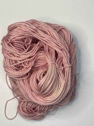 Pink Colorway: Variegated Rose. 219 yards / 200 meters. 100 grams Variegated Rose Worsted 4-ply  yarn is naturally dyed with sustainably harvested/foraged dye material from plants, minerals, roots, trees, and other organic materials. Blue Thistle Fiber’s 4-ply Worsted yarn is certified mulesing-free SW 100% Merino wool and quickly works up into hats and sweaters everyone will love to wear. A durable yarn that holds up to washing and wearing. Care Instructions: Machine wash on a gentle cycle using mild detergent. Do not bleach. Dry flat away from direct sunlight. <strong>While our team hand-dyes each skein with the utmost care, natural dyes results can vary based on plant materials and fibers. </strong><strong>Please wash before using, as naturally dyed fibers can run the first few washings.</strong> <strong>Please be aware that variations in color and appearance may vary from the display image.</strong>  