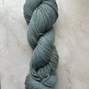 Green Colorway: Dark Sage. Length: 383 yards | 350 m | 100 g Dark Sage 4-ply eco-sock wool yarn is made from 50% Recycled Wool & 50% Tencel for durability.  This sustainable yarn is ethically sourced from Peru and naturally dyed in West Virginia.  This wool has a crisp, bulky feel and is perfect for apparel and other projects.  